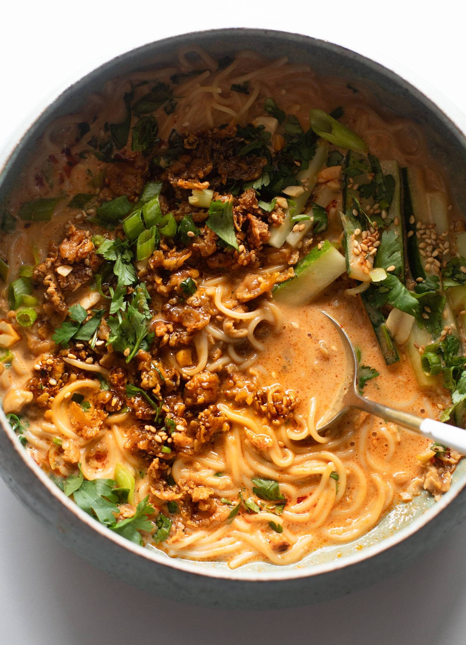 Miso peanut ramen in a bowl topped with green onion.