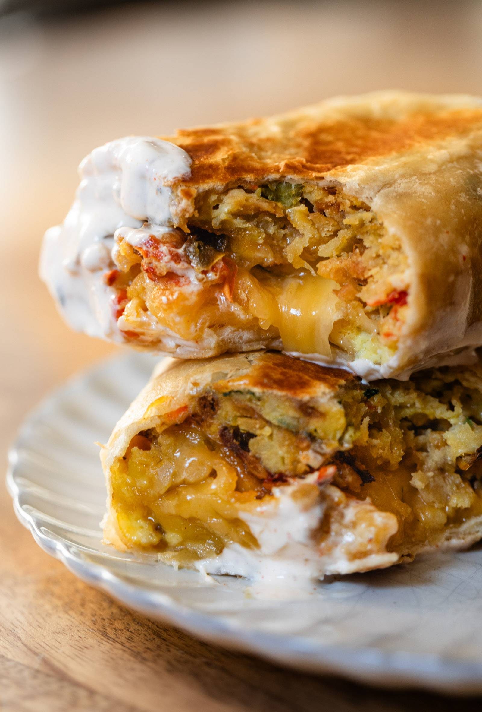 Breakfast burrito cut in half and dipped in chipotle sauce
