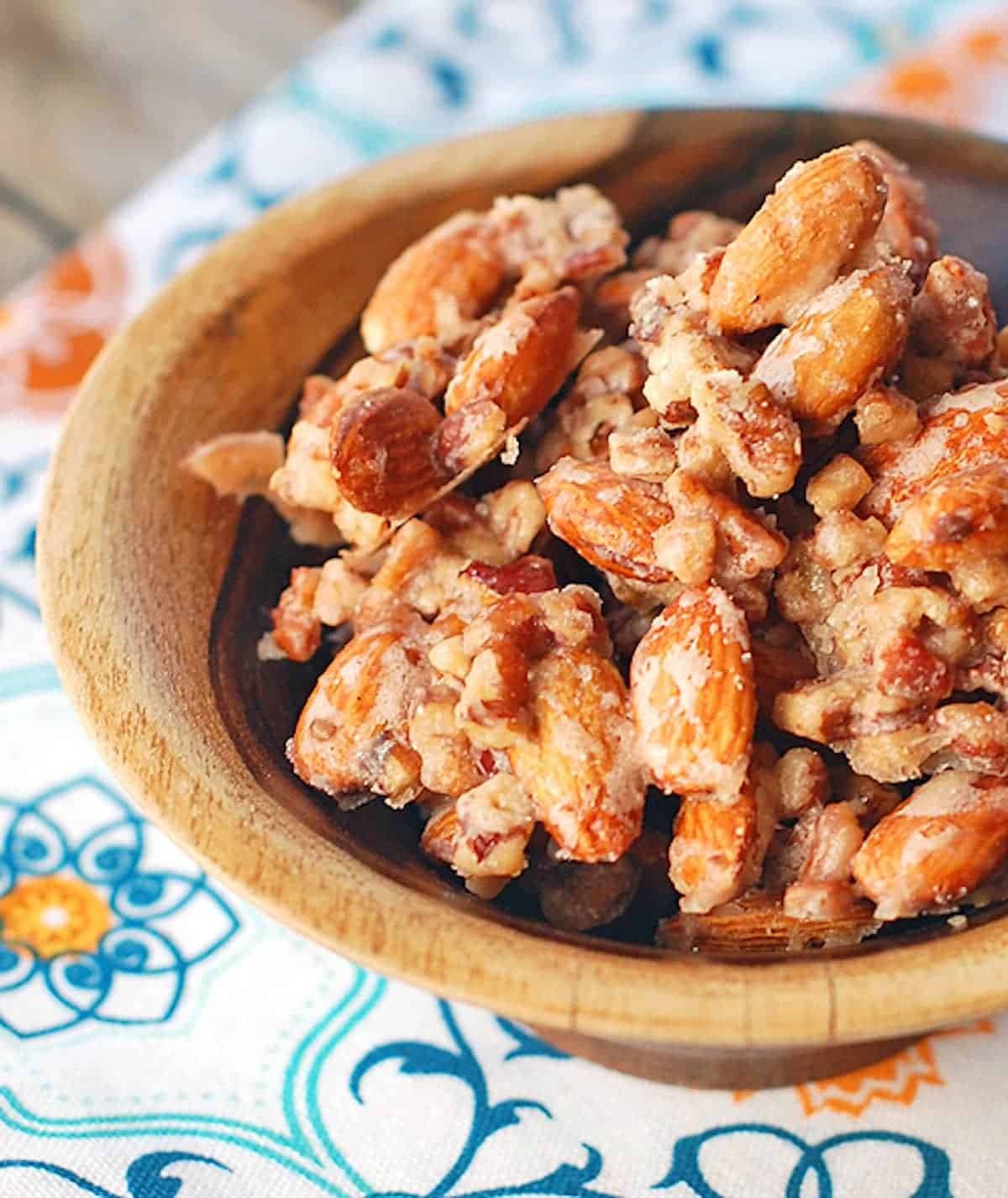 Maple vanilla almond clusters in a wooden bowl.